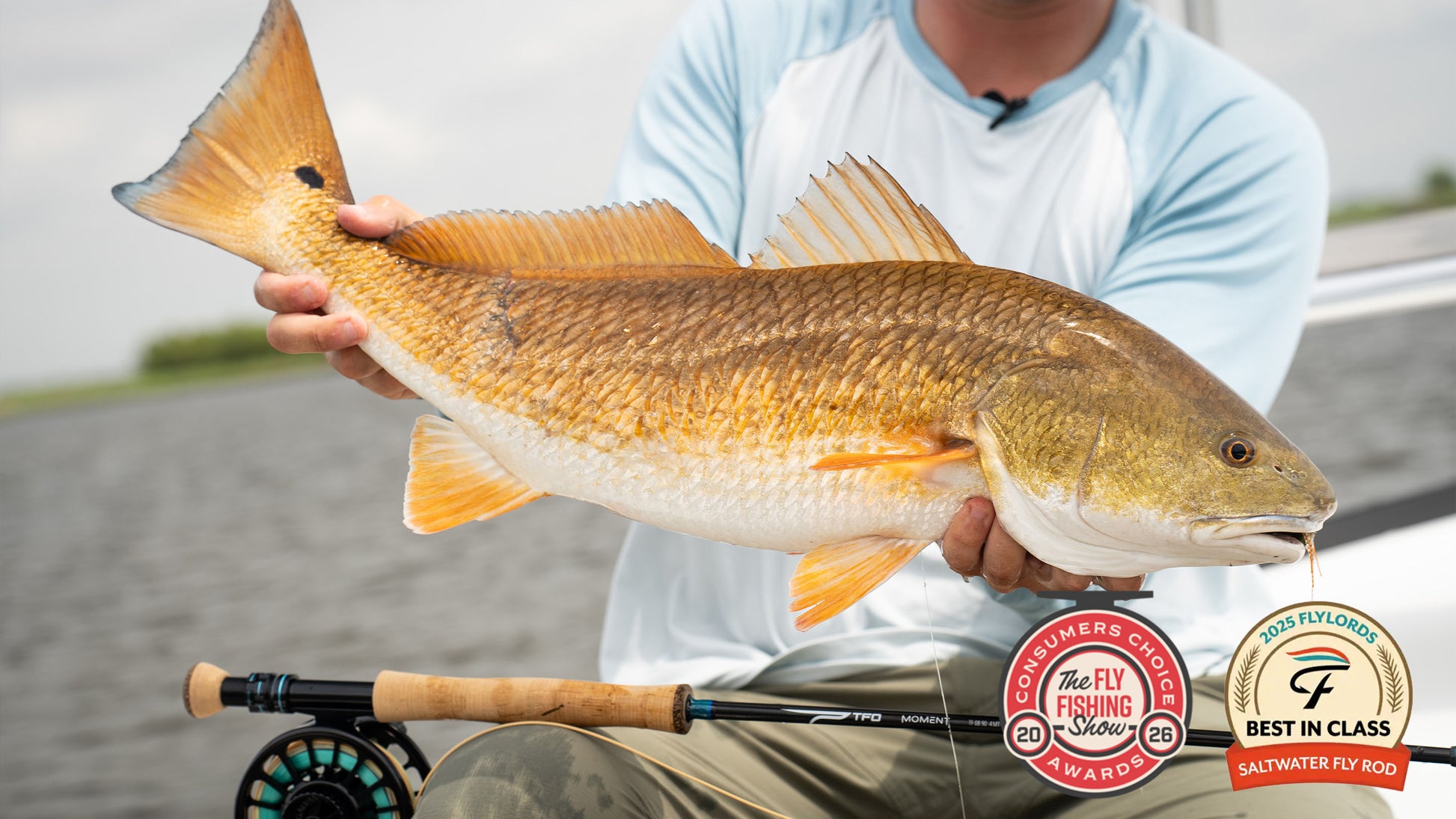 Angler with redfish caught on TFO Moment fly rod